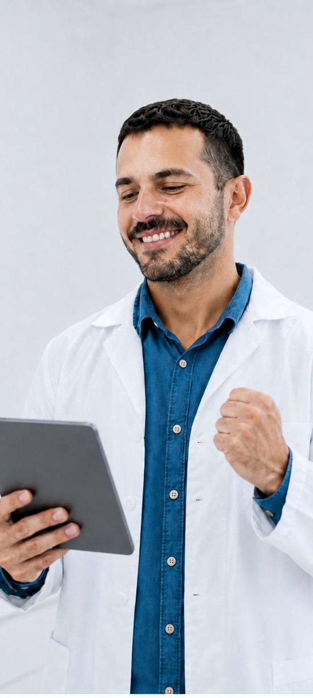 A dentist smiling at a finished case